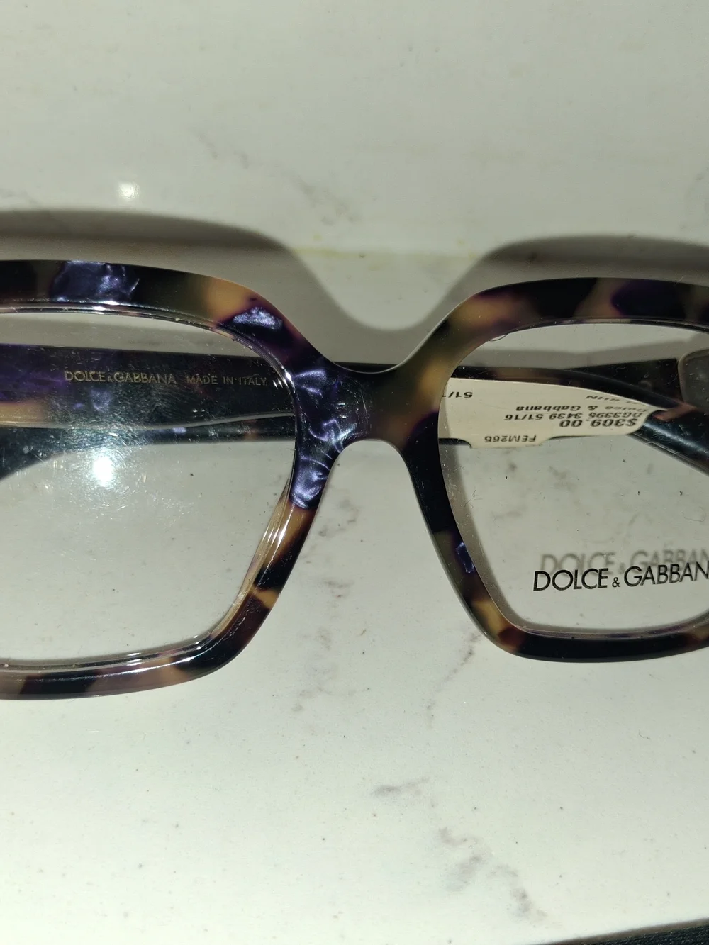 Dolce & Gabbana DG3395 eyeglasses feature a striking Havana Blue Pearl tortoises